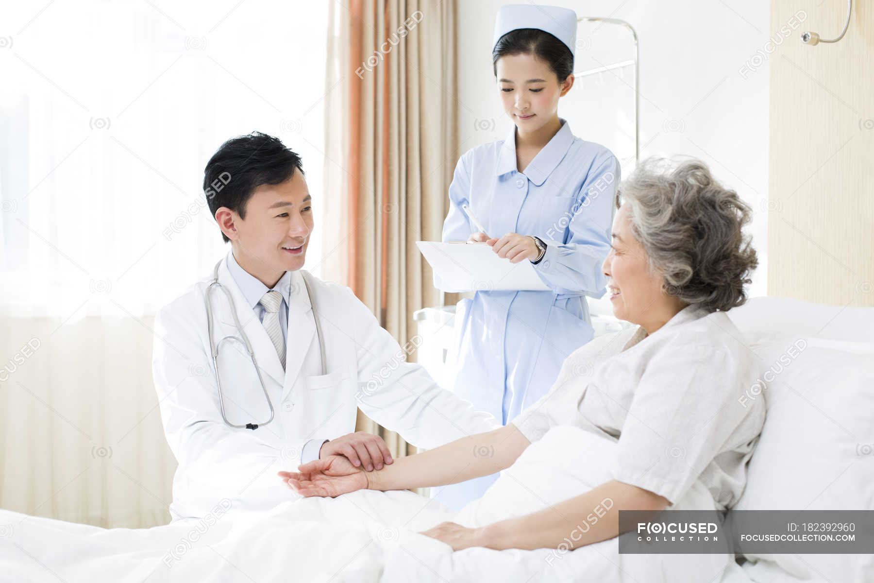 focused 182392960 stock photo chinese doctor taking pulse patient